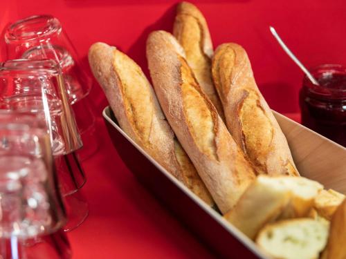 a box of french bread and butter on a red table at hotelF1 Poitiers Nord Futuroscope in Chasseneuil-du-Poitou