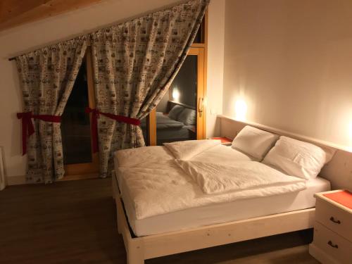 Postel nebo postele na pokoji v ubytování Millennium Stube Locazione Turistica