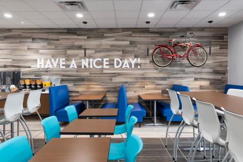 a restaurant with tables and chairs and a bike on the wall at Hotel Monreale Express International Drive Orlando in Orlando