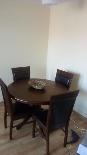 a wooden table with chairs and a bowl on top at Atacama Valley 5 in Copiapó