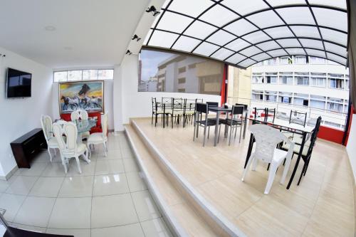 a dining room with tables and chairs in a building at HOTEL DON QUIJOTE in Pereira