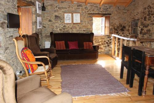 a living room with a couch and a piano at Casa da Carvalha in Lousã