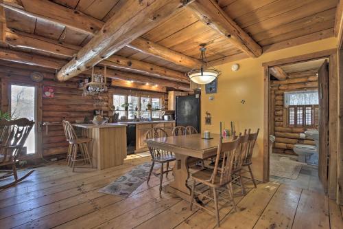 a dining room and kitchen with a table and chairs at Cabin Private Hot Tub, Walk to Pats Peak Ski Area in Henniker