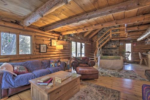 a living room with a couch and a table at Cabin Private Hot Tub, Walk to Pats Peak Ski Area in Henniker