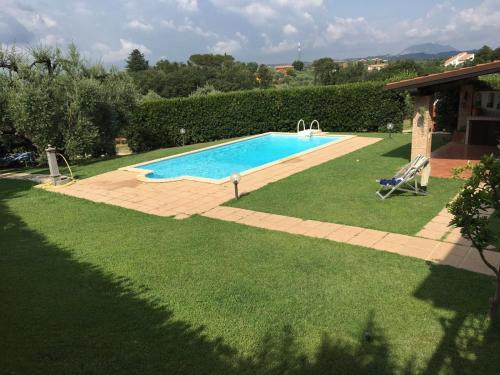a swimming pool in a yard next to a yard at Le Vecchie Scuderie in Passo Corese