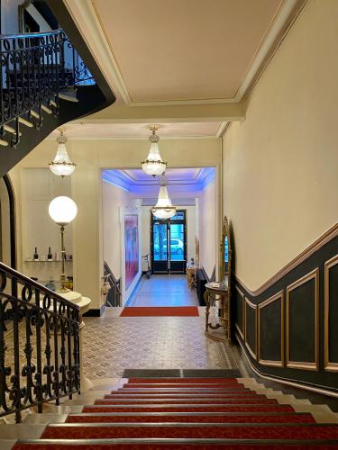 a hallway of a building with a staircase and a stair case at Salon Boyer in Épernay
