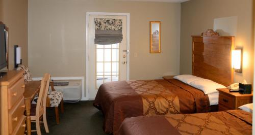 Tempat tidur dalam kamar di Four Seasons Country Inn