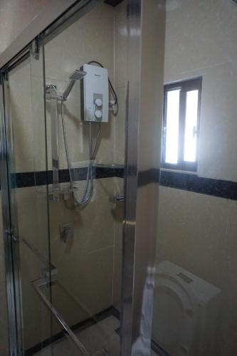 a shower in a bathroom with a glass shower stall at Holiday Hire Fiji in Lautoka
