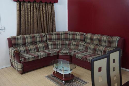 a living room with a couch and a glass table at Holiday Hire Fiji in Lautoka