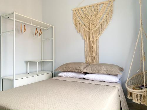 a bed with two pillows on it in a room at Conforto em Copacabana- 100m da praia - BR1033 in Rio de Janeiro