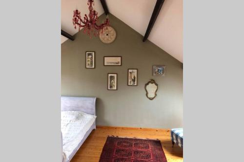 a bedroom with a bed and a chandelier at Appartement dans un bâtiment historique in Thorembais-Saint-Trond