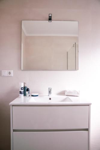 a bathroom with a white sink and a mirror at Marlin House II in Ferrel