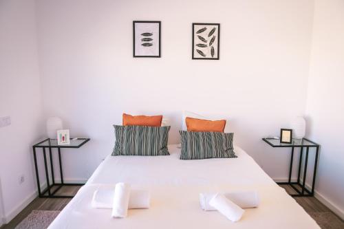 a bedroom with a white bed with two side tables at Marlin House II in Ferrel