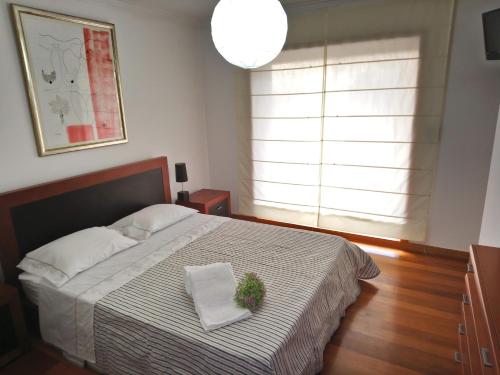 a bedroom with a bed with a plant on it at Beach House - Between Porto and Viana do Castelo in Esposende