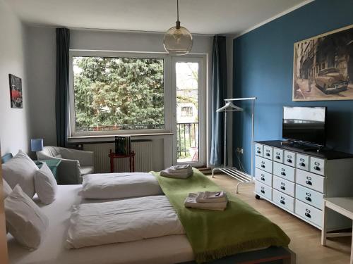 a bedroom with a large bed and a window at Gästeträume Im Viertel in Bremen
