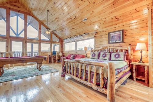 a bedroom with a bed and a pool table in a cabin at Sweet Surrender in Pigeon Forge