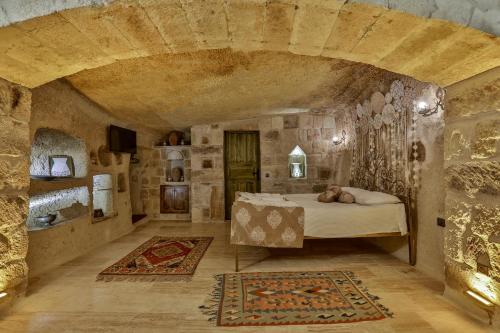 Ένα ή περισσότερα κρεβάτια σε δωμάτιο στο Casia Cave Suites