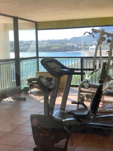 a gym with a view of the water at Condominios San Carlos in San Carlos