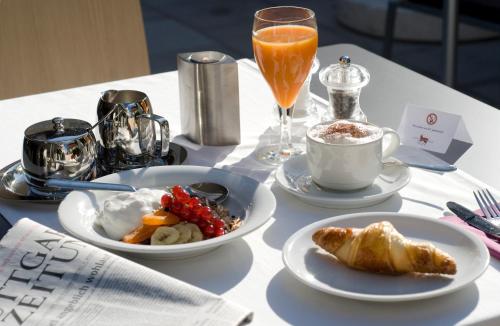 a table with plates of food and drinks on it at Landidyll Hotel Lamm in Vaihingen an der Enz