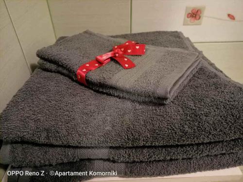 a pile of towels with a red ribbon on them at Apartament Komorniki in Komorniki