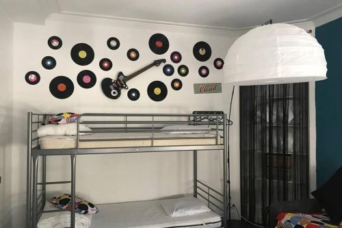 a wall with a bunch of records on a wall at Studio POP DESIGN in Milly-la-Forêt