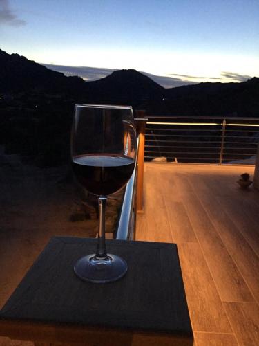 a glass of wine sitting on top of a table at Tenuta Petra Manna in Palau