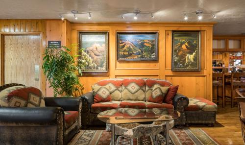 a living room with a couch and a table at Grand Canyon Inn and Motel - South Rim Entrance in Valle