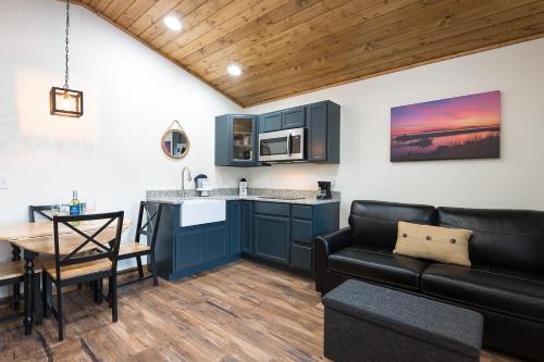 a kitchen and living room with a couch and a table at Woodland Inns in Forks