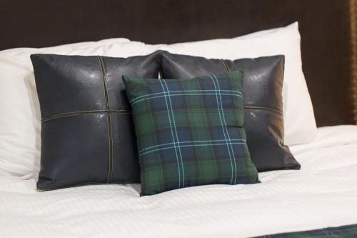 a group of pillows sitting on top of a bed at Woodland Inns in Forks
