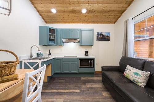 a kitchen and a living room with a couch at Woodland Inns in Forks