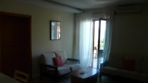 a living room with a couch and a chair at Guest house Živković in Sveti Stefan