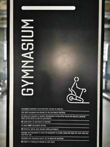 a poster of a person riding a scooter at Tamarind Suites by BeeStay Management in Cyberjaya