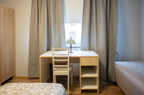 a bedroom with a bed and a desk at Bed&Breakfast Tuure in Turku