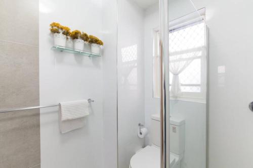 a bathroom with a toilet and a glass shower at B2 Crawley Apartment 1 BRM & Sleepout near UWA in Perth