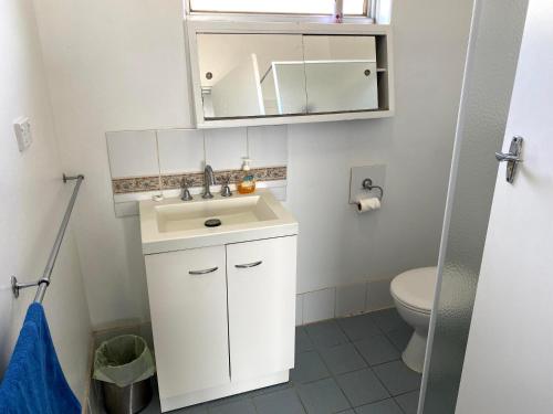 a bathroom with a white sink and a toilet at Waldeck Heights in Geraldton