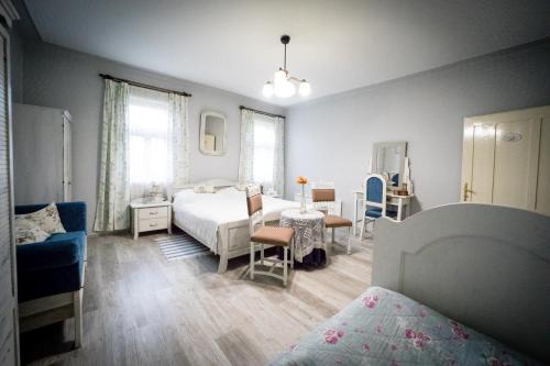 1 dormitorio con 1 cama, mesa y sillas en Spalettás Porta - Vidéki Vendégház, en Őrtilos