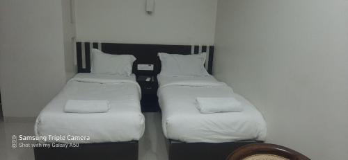 A bed or beds in a room at Hotel Sai Panchvati