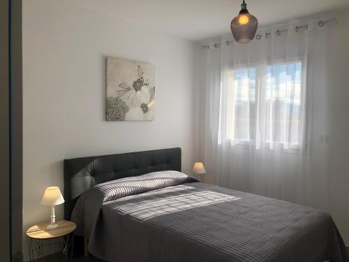 a bedroom with a bed and a window at U SOLE in Ajaccio