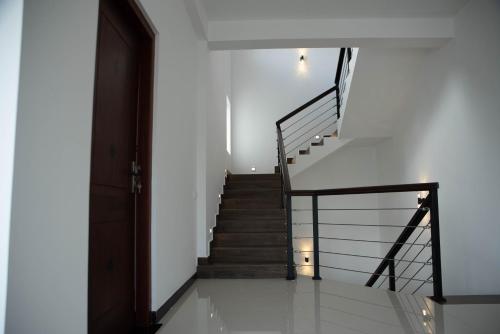 a staircase in a house with a stair case at White Castle in Wadduwa