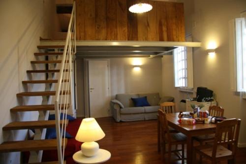 a living room with a staircase and a dining room at Tenuta Agricola Fonte Di Papa in Monterotondo