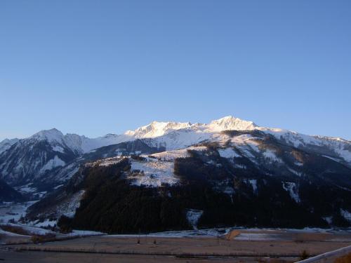 a view of a mountain with snow capped mountains at Appartements Wallner in Uttendorf