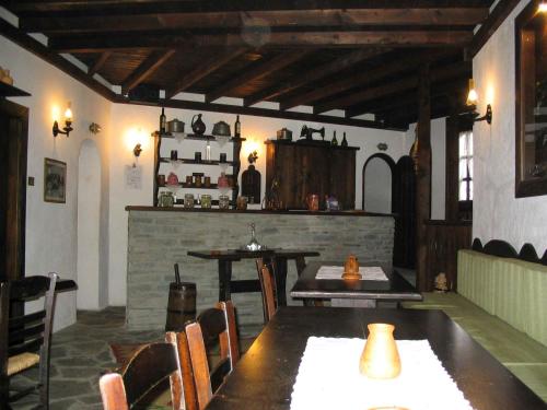 a dining room with a table and chairs and a bar at Traditional Guesthouse Lanari in Livádion