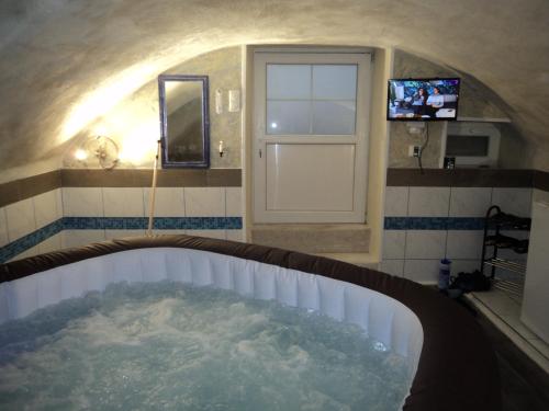 a bathroom with a tub with water in it at Gîte La Lieutenance in Saint-Pourçain-sur-Sioule