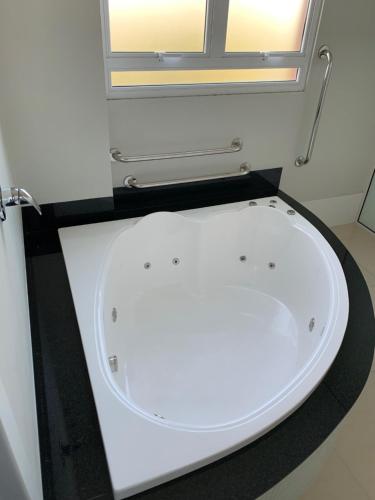 a white toilet in a bathroom with a window at Hotel Catarina in São Miguel dʼOeste