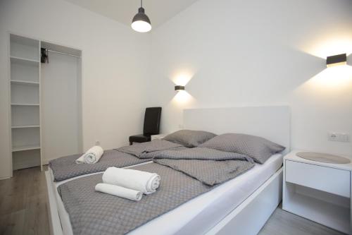 a bedroom with a bed with towels on it at Miaap Apartments in Sarajevo