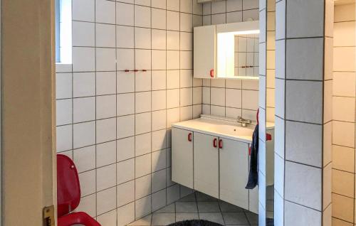 un piccolo bagno con lavandino e sedia rossa di 3 Bedroom Beautiful Home In Hejls a Hejls