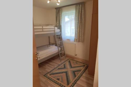 a small room with a bunk bed and a window at Ferienwohnung Heindl in Bad Ischl