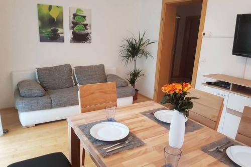 a living room with a table and a couch at Ferienwohnung Heindl in Bad Ischl