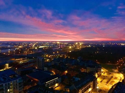 a view of a city at night with lights at 22ndFloor Luxury Suite in Ostend