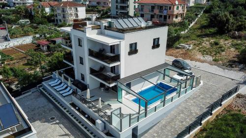 an aerial view of a house with a swimming pool at Villa 23 A heated pool in Trogir